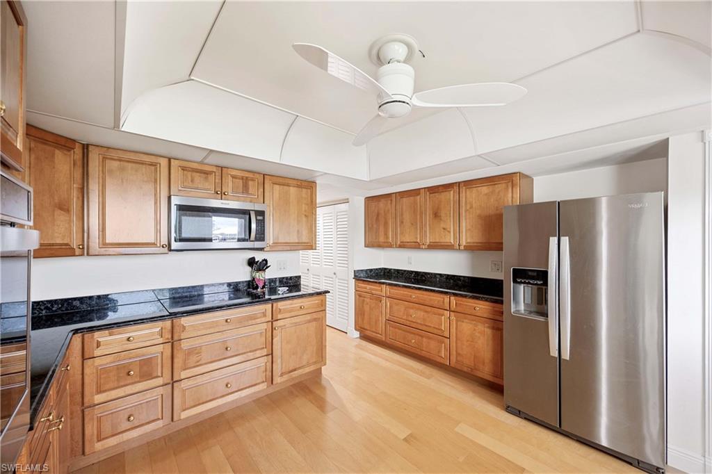 330 Kon Tiki Drive, Unit A2 Naples, FL 34113 - Photo 16 of 39 a kitchen with granite countertop a sink a counter space appliances and cabinets