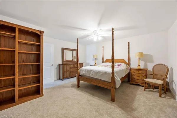 a bedroom with a bed a table and chair