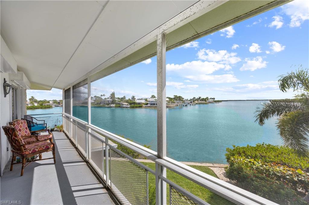 330 Kon Tiki Drive, Unit A2 Naples, FL 34113 - Photo 29 of 39 a view of a lake from a balcony