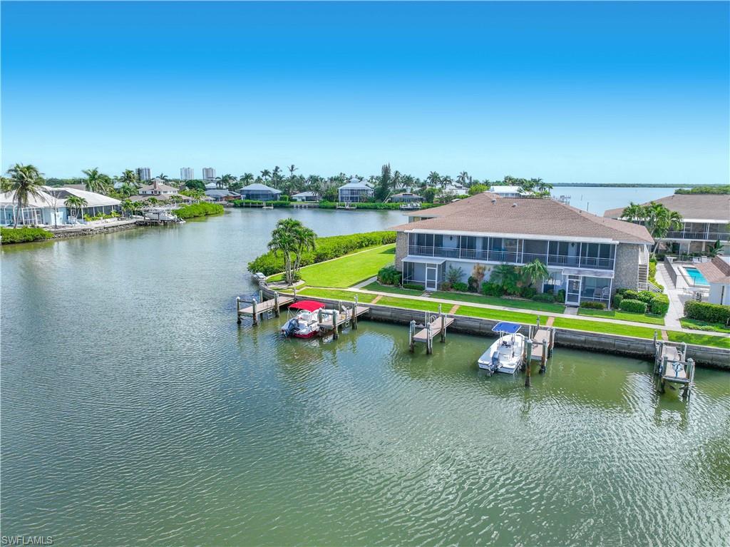 330 Kon Tiki Drive, Unit A2 Naples, FL 34113 - Photo 32 of 39 a view of swimming pool with outdoor seating space