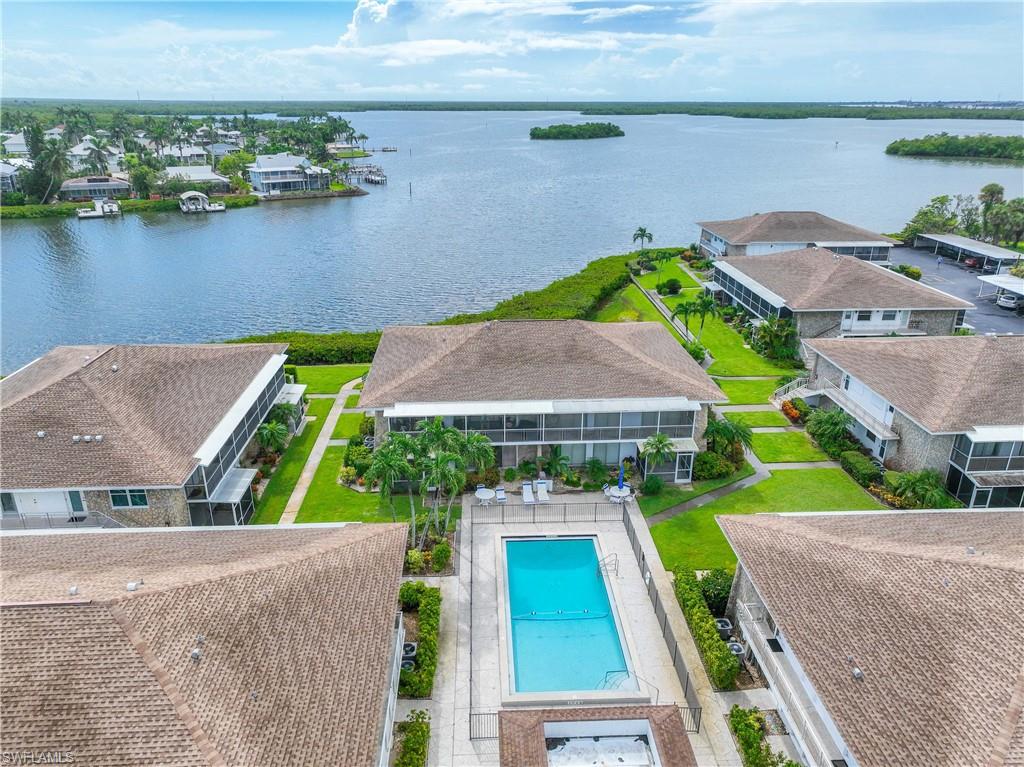 330 Kon Tiki Drive, Unit A2 Naples, FL 34113 - Photo 37 of 39 an aerial view of house with yard and lake view