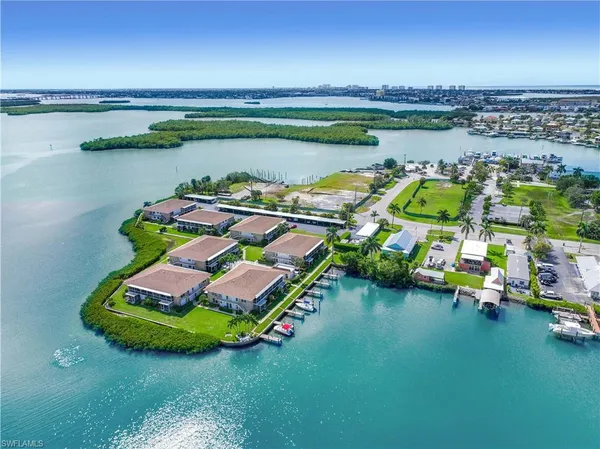 a view of a lake with lawn chairs