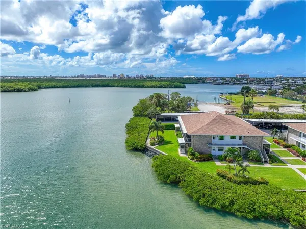 a aerial view of a house with a garden and lake view
