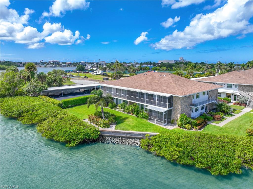 330 Kon Tiki Drive, Unit A2 Naples, FL 34113 - Photo 7 of 39 a view of a garden with a house