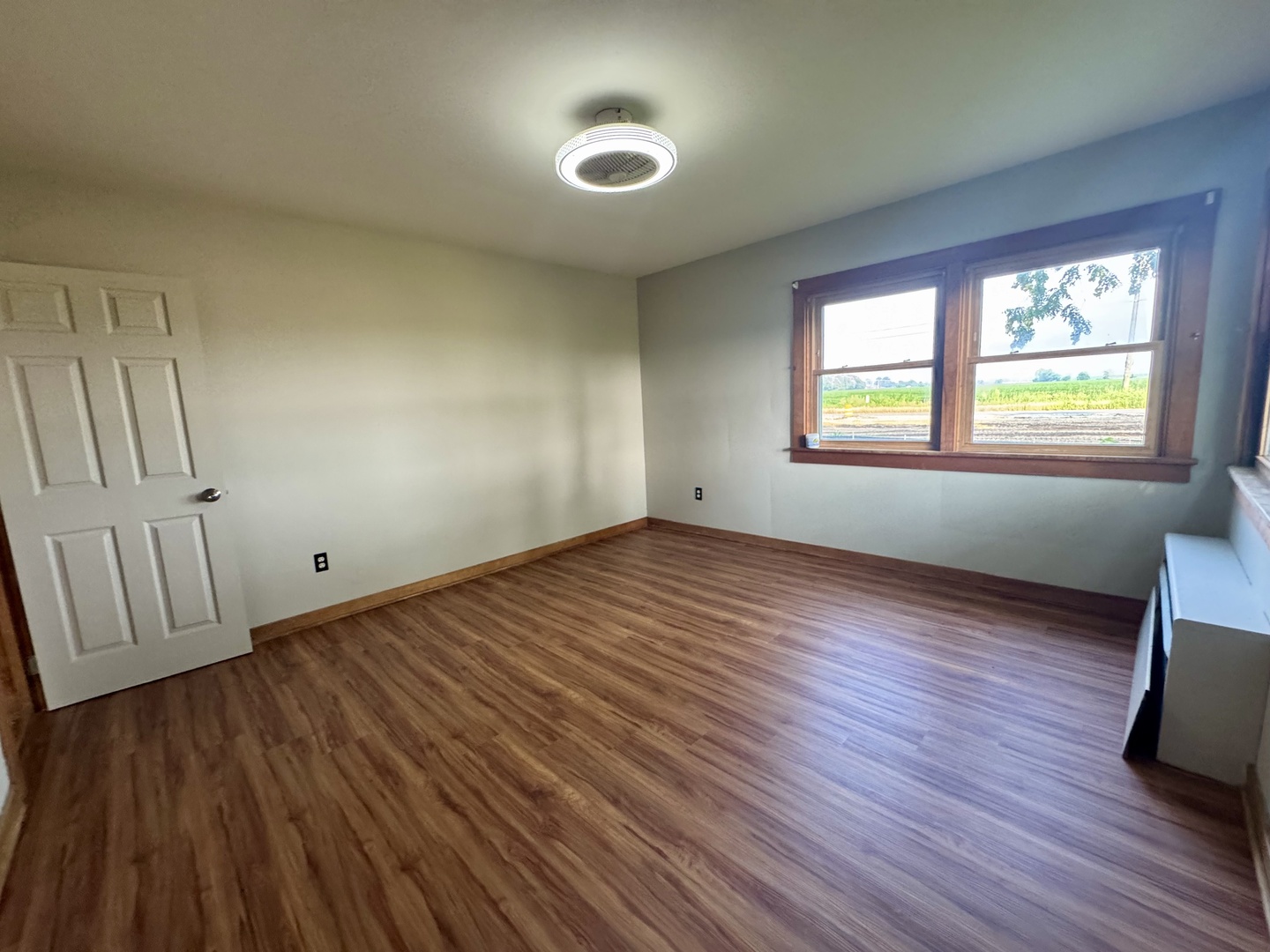 6809 Highway 71 Oswego, IL 60543 - Photo 9 of 20 an empty room with wooden floor and windows