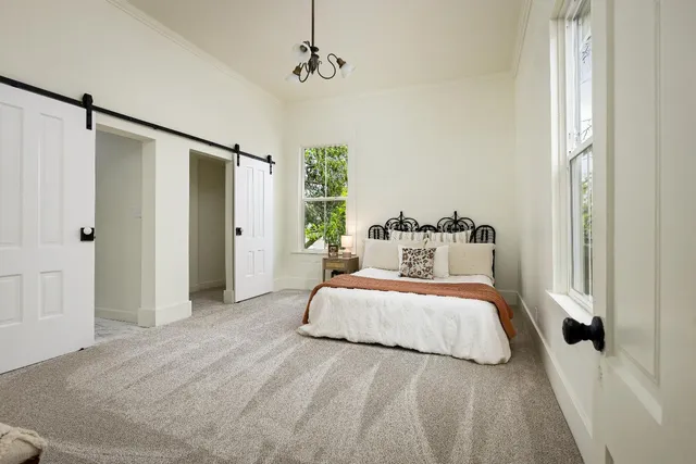 a bedroom with a bed and a window