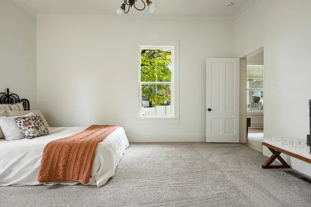 a bathroom with a granite countertop sink a toilet and a mirror