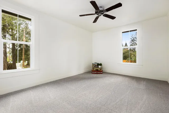 an empty room with windows and closet