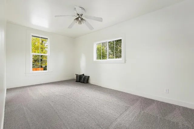 a backyard of a house with table and chairs