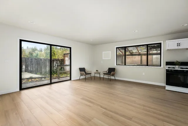 a kitchen with stainless steel appliances a refrigerator sink and white cabinets