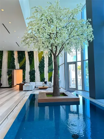 a kitchen with granite countertop a refrigerator and a stove top oven