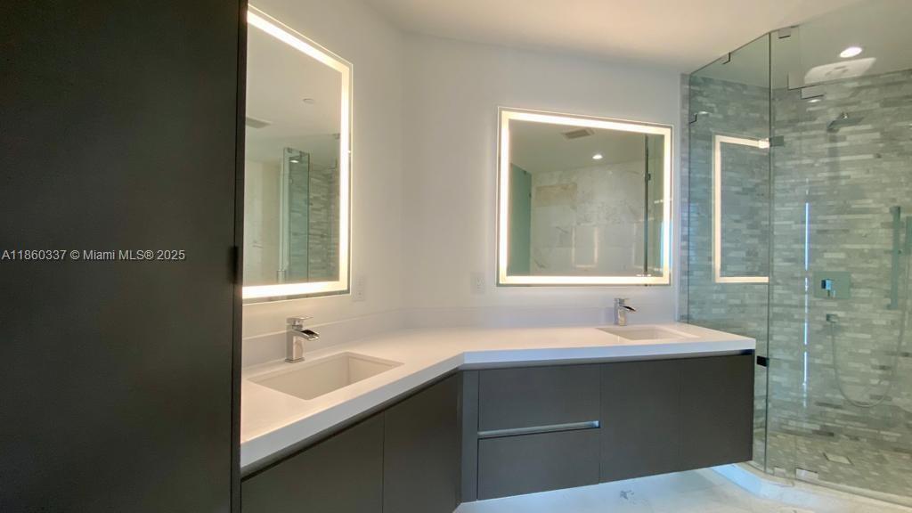 851 Northeast 1st Avenue, Unit 3904 Miami, FL 33132 - Photo 23 of 28 a bathroom with a sink and a mirror