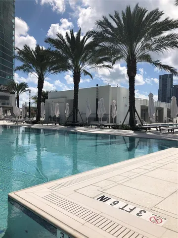 a view of swimming pool with a table and chairs