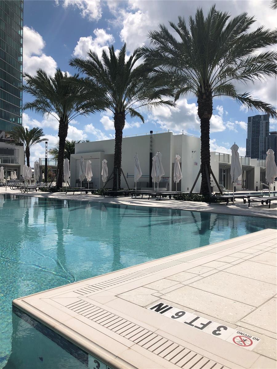 851 Northeast 1st Avenue, Unit 3904 Miami, FL 33132 - Photo 9 of 28 a view of swimming pool with a table and chairs