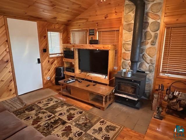 2377 Finn Road Babbitt, MN 55706 - Photo 31 of 32 Living room featuring lofted ceiling, a wood stove, wood finished floors, wooden ceiling, and wooden walls