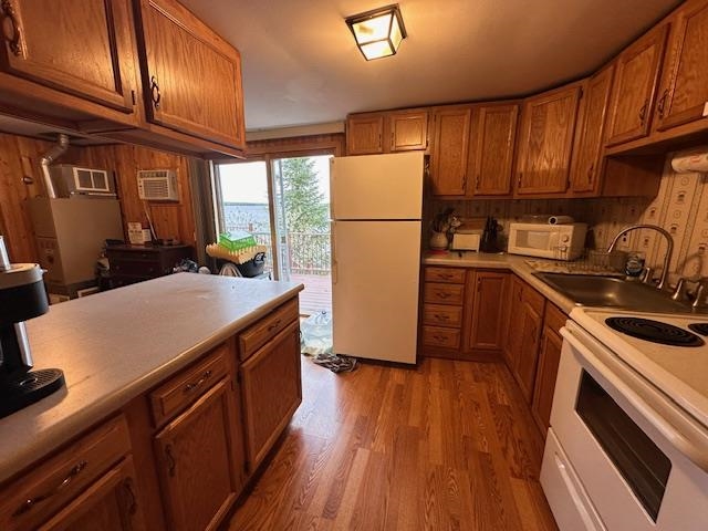 2377 Finn Road Babbitt, MN 55706 - Photo 6 of 32 Kitchen featuring white appliances, a sink, light wood-style flooring, and brown cabinets