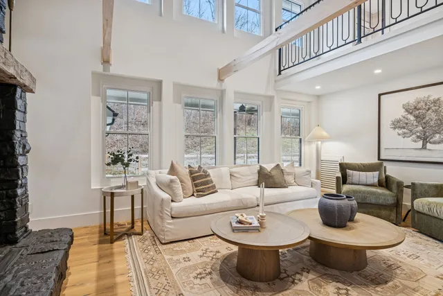 a view of a swimming pool with a yard from a balcony