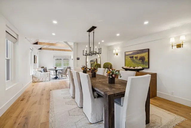a living room with furniture and two windows