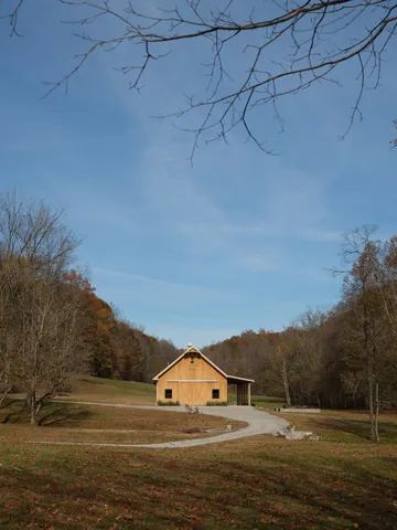 a kitchen with a dining table chairs sink and wooden floor