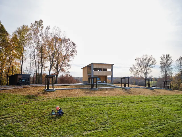 a big yard with lots of green space and house in the back