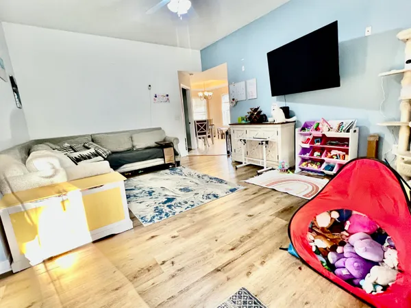 a living room with furniture and a flat screen tv