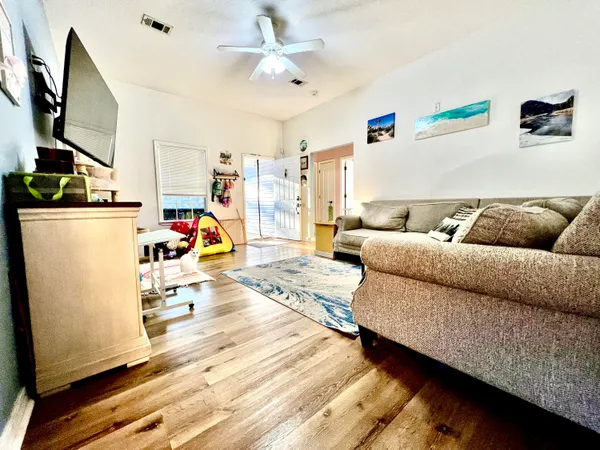 a living room with furniture and a flat screen tv