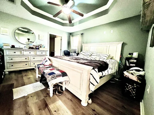 a bedroom with a bed and a chandelier