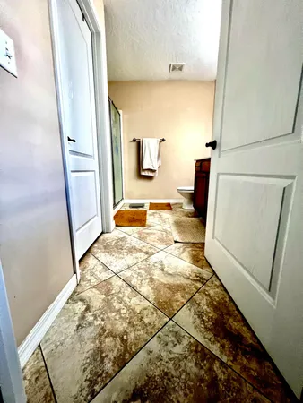 a bedroom with a bed and a flat tv screen on the dresser