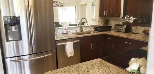 a kitchen with a sink and a refrigerator