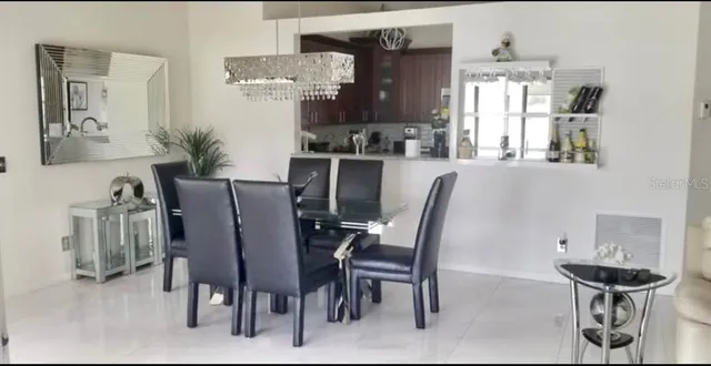 a dining room with furniture and window