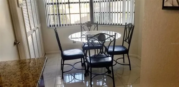 a view of a dining room with furniture and a window