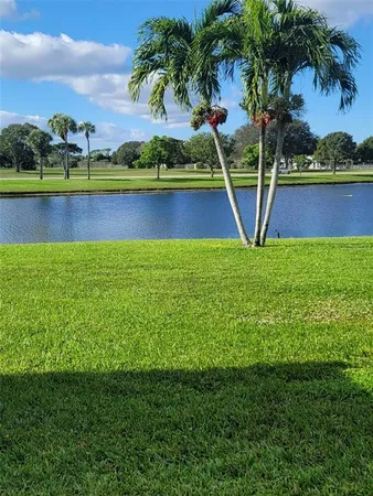 a view of a swimming pool with a lake and houses in the back