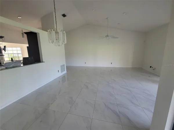 an empty room with a fireplace and window