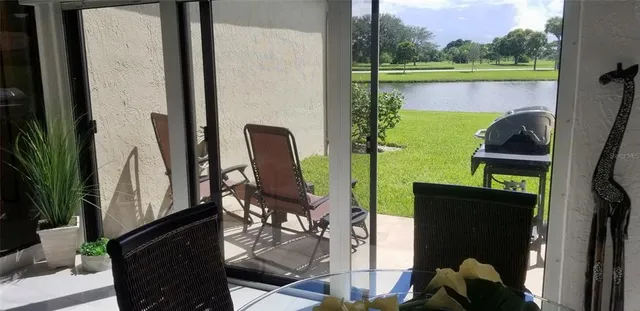 a view of a balcony with chair and potted plants
