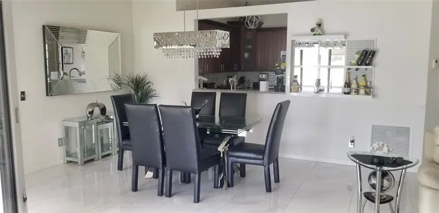 a view of a dining room with furniture and chandelier