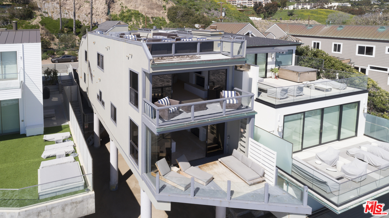 a balcony with furniture and a fireplace