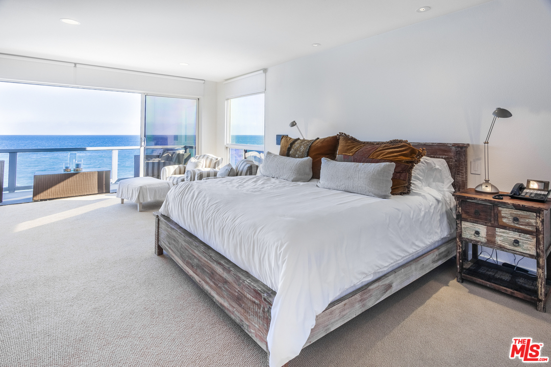 23952 Malibu Road Malibu, CA 90265 - Photo 13 of 23 a large bedroom with bed and a large window