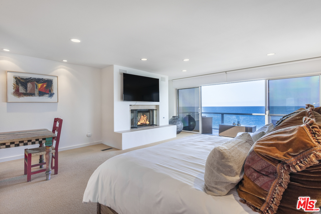 23952 Malibu Road Malibu, CA 90265 - Photo 14 of 23 a bedroom with a bed and a flat screen tv