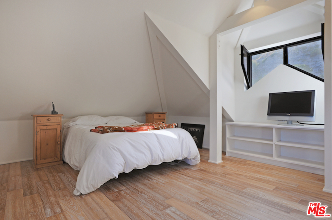 23952 Malibu Road Malibu, CA 90265 - Photo 19 of 23 a bedroom with a bed and a flat screen tv