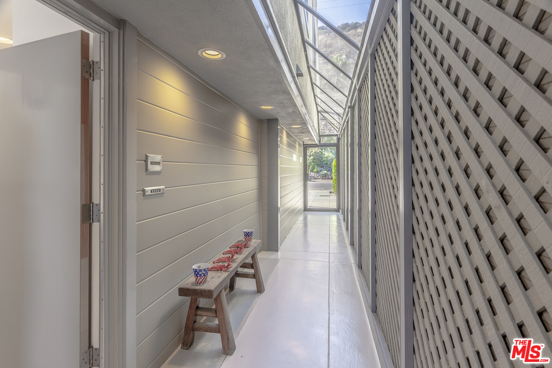 23952 Malibu Road Malibu, CA 90265 - Photo 23 of 23 a hallway with a bench and a shower