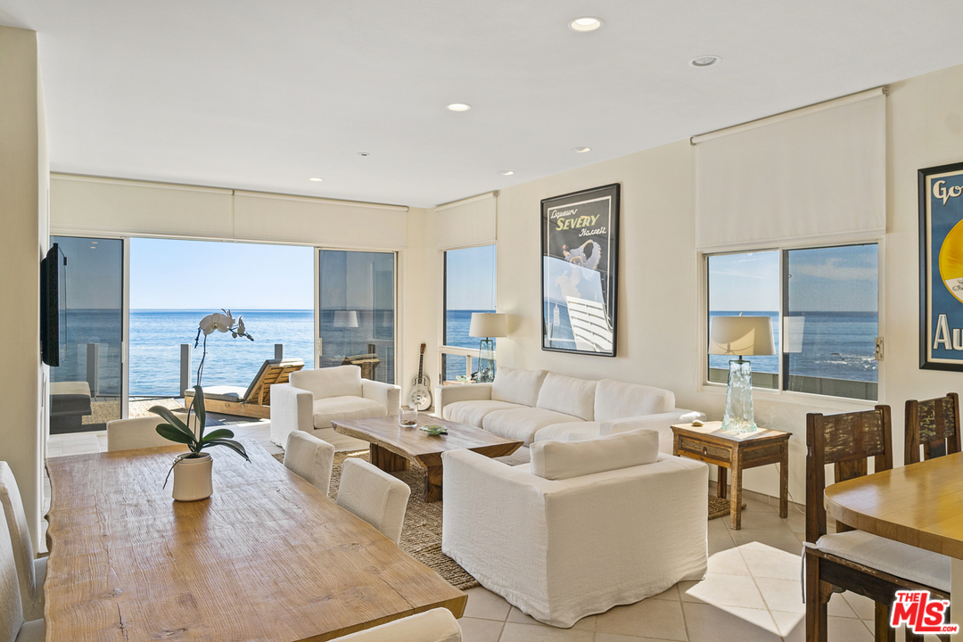 23952 Malibu Road Malibu, CA 90265 - Photo 5 of 23 a living room with fireplace furniture and a large window