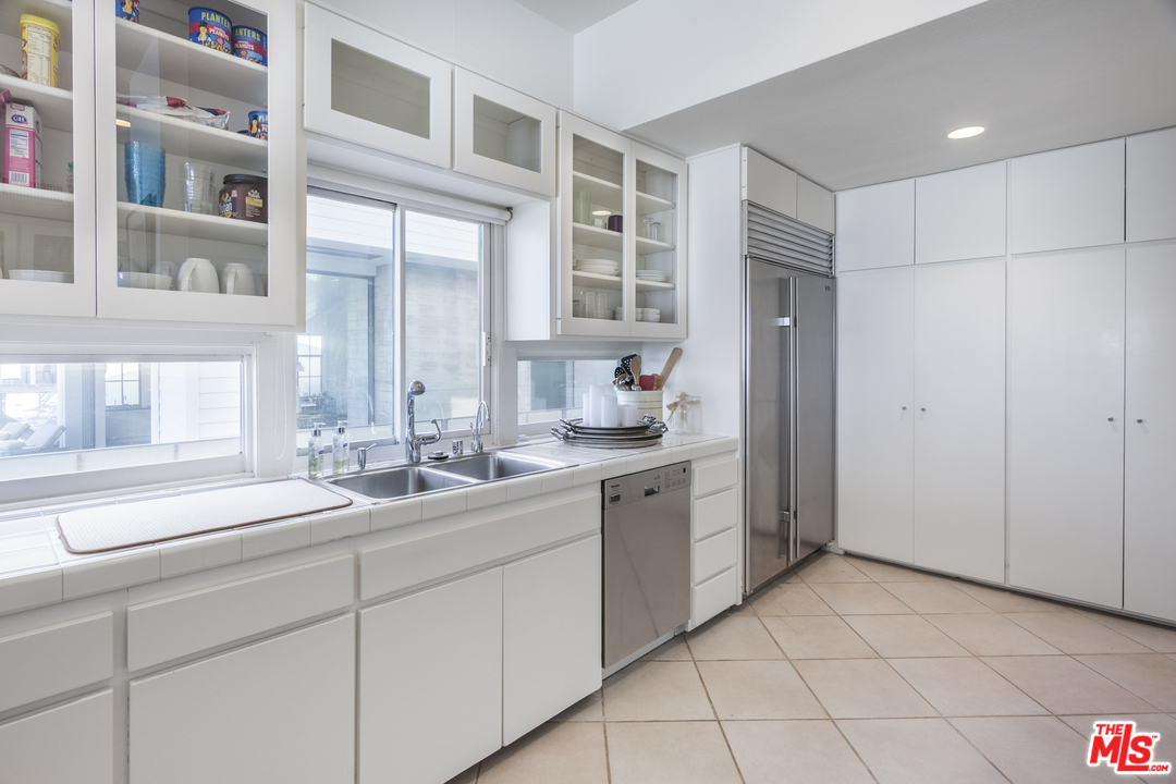 23952 Malibu Road Malibu, CA 90265 - Photo 8 of 23 a spacious bathroom with a double vanity sink a mirror and a shower