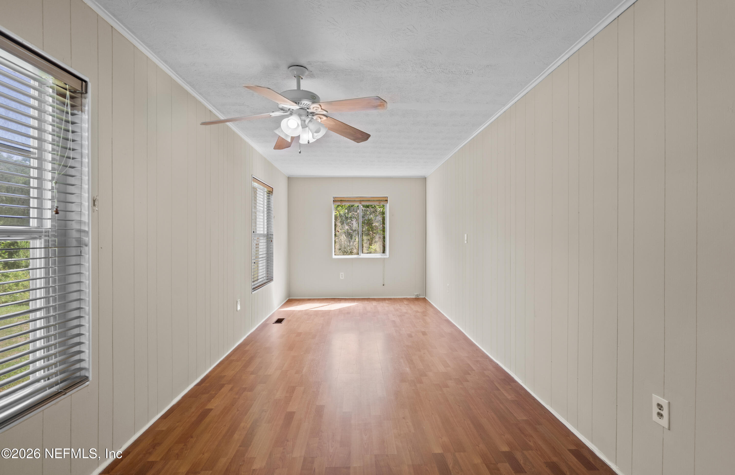 253 Cowry Road St. Augustine, FL 32086 - Photo 15 of 27 wooden floor in an empty room with a window