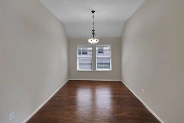 a view of a room with window and wooden floor