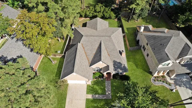 an aerial view of a house with a yard and garden