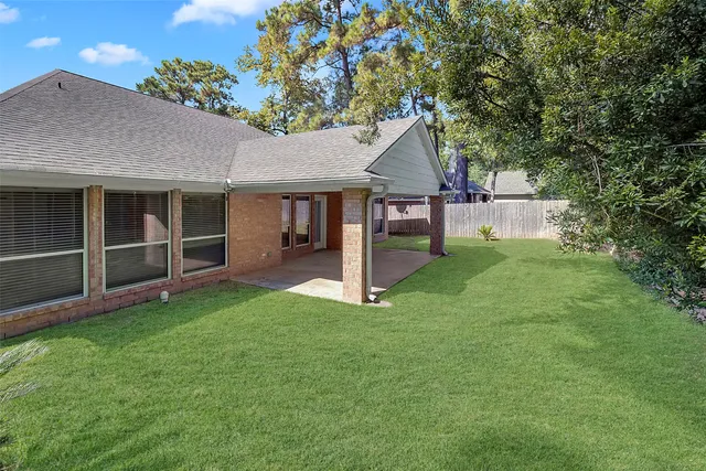 a view of a house with a yard and porch
