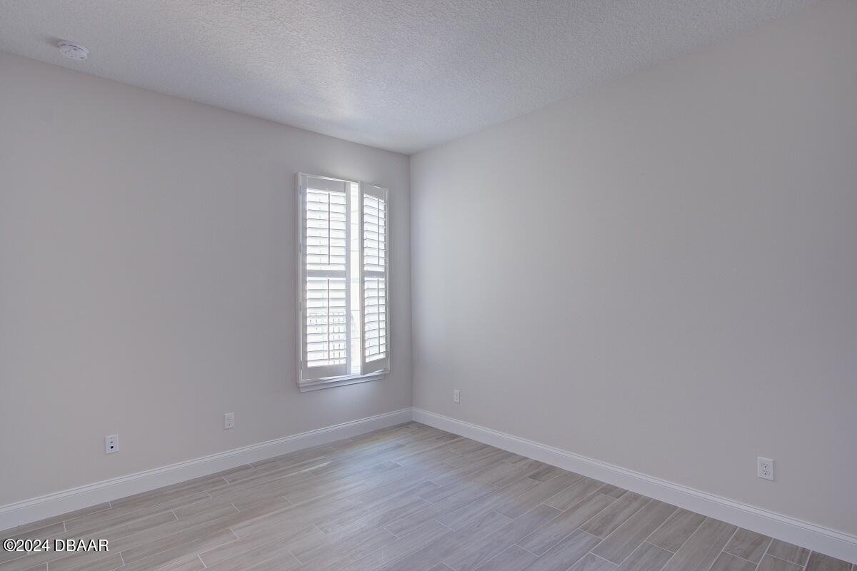 8 Finch Walk Road Ormond Beach, FL 32174 - Photo 11 of 18 an empty room with wooden floor and windows