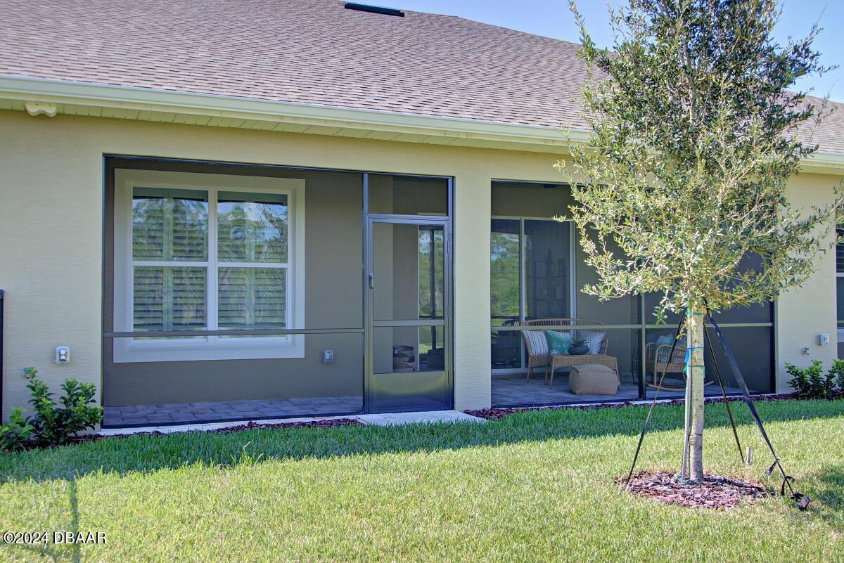 8 Finch Walk Road Ormond Beach, FL 32174 - Photo 16 of 18 a view of an house with backyard and a tree