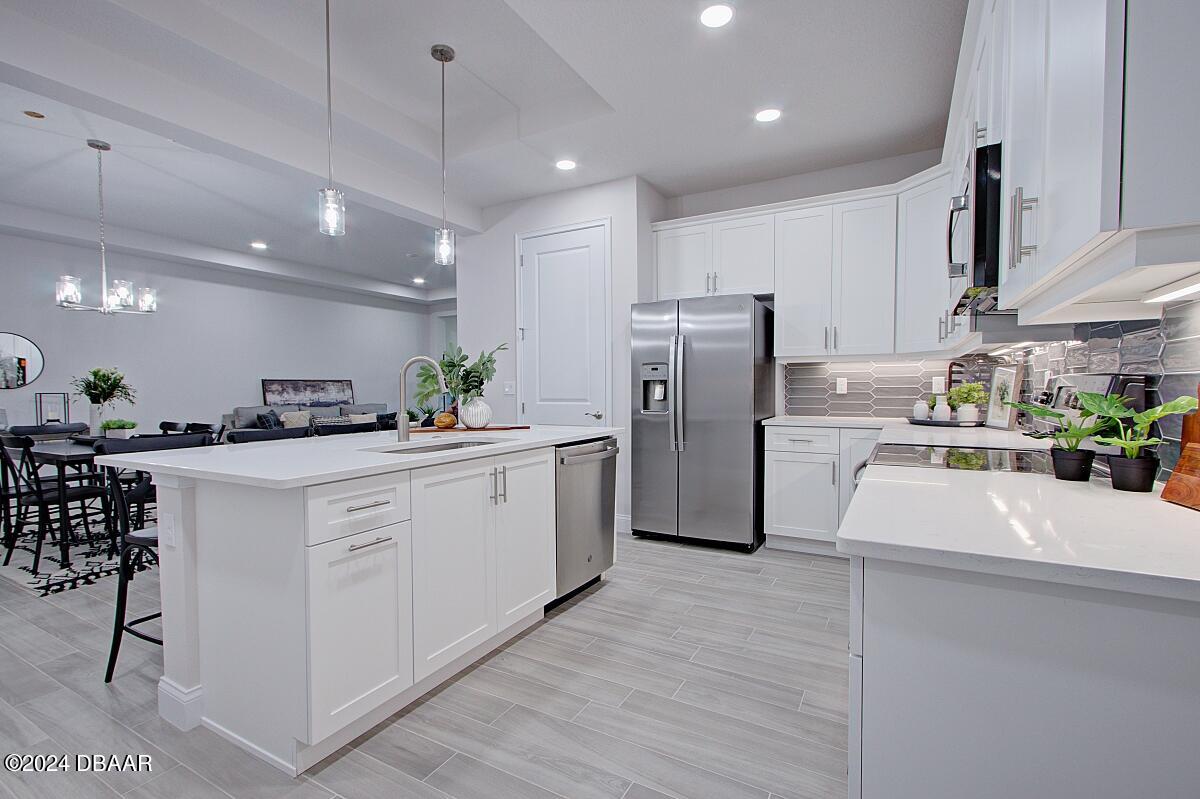 8 Finch Walk Road Ormond Beach, FL 32174 - Photo 4 of 18 a kitchen with refrigerator and cabinets