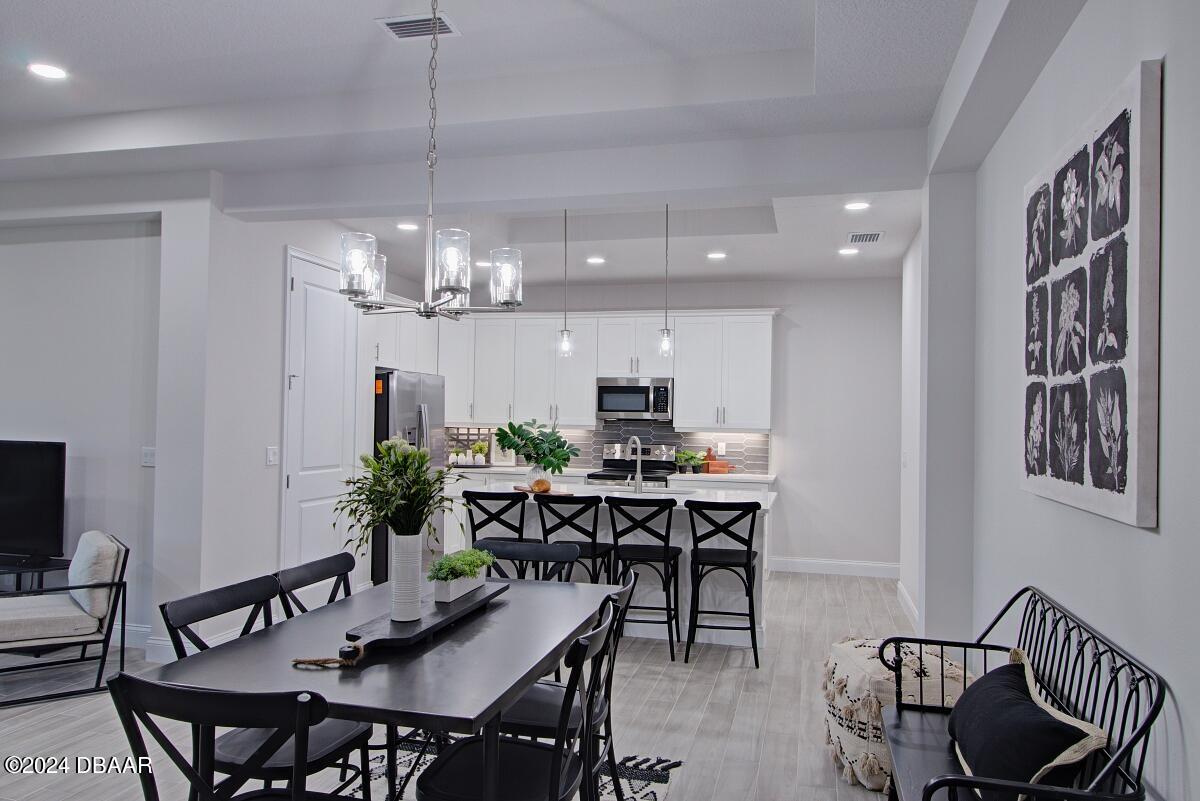 8 Finch Walk Road Ormond Beach, FL 32174 - Photo 5 of 18 a view of a dining room with furniture and chandelier